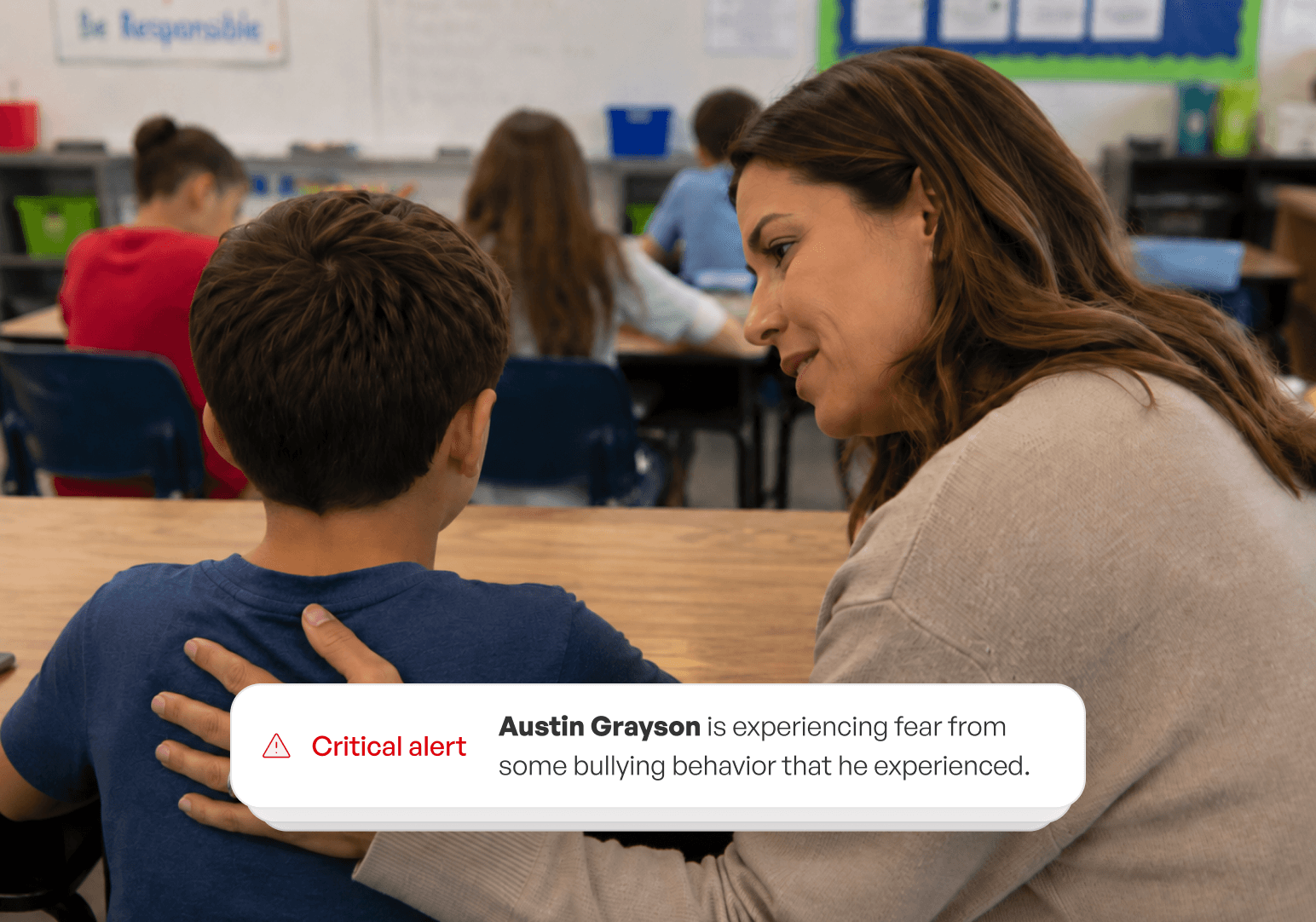 Teacher comforting a student with a critical alert notification about a bullying concern